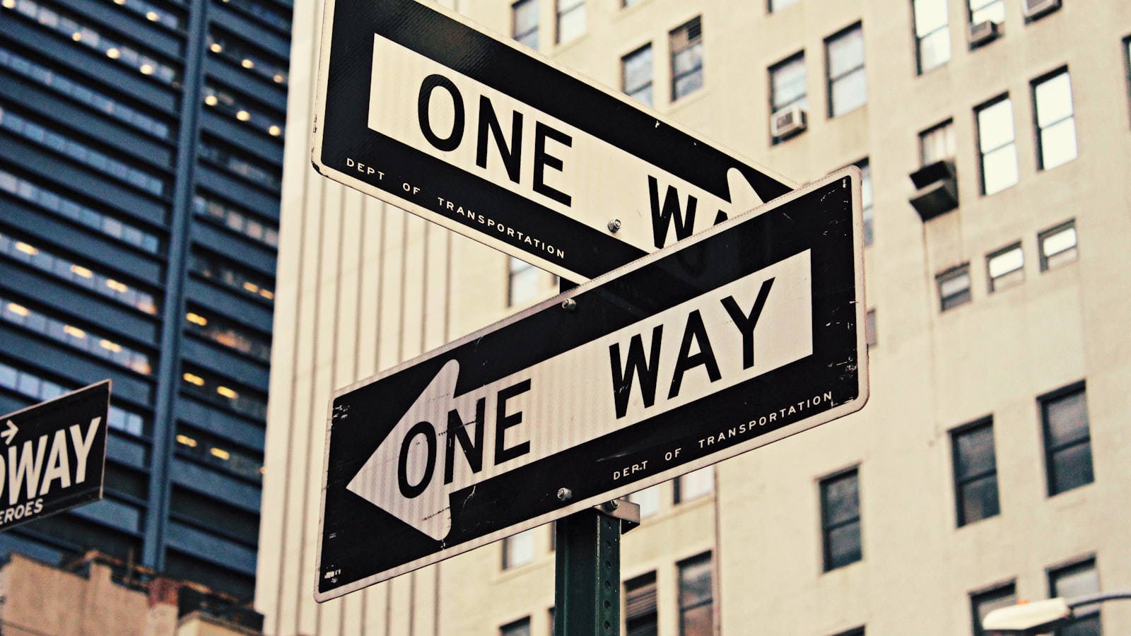 White and black one way printed road signages